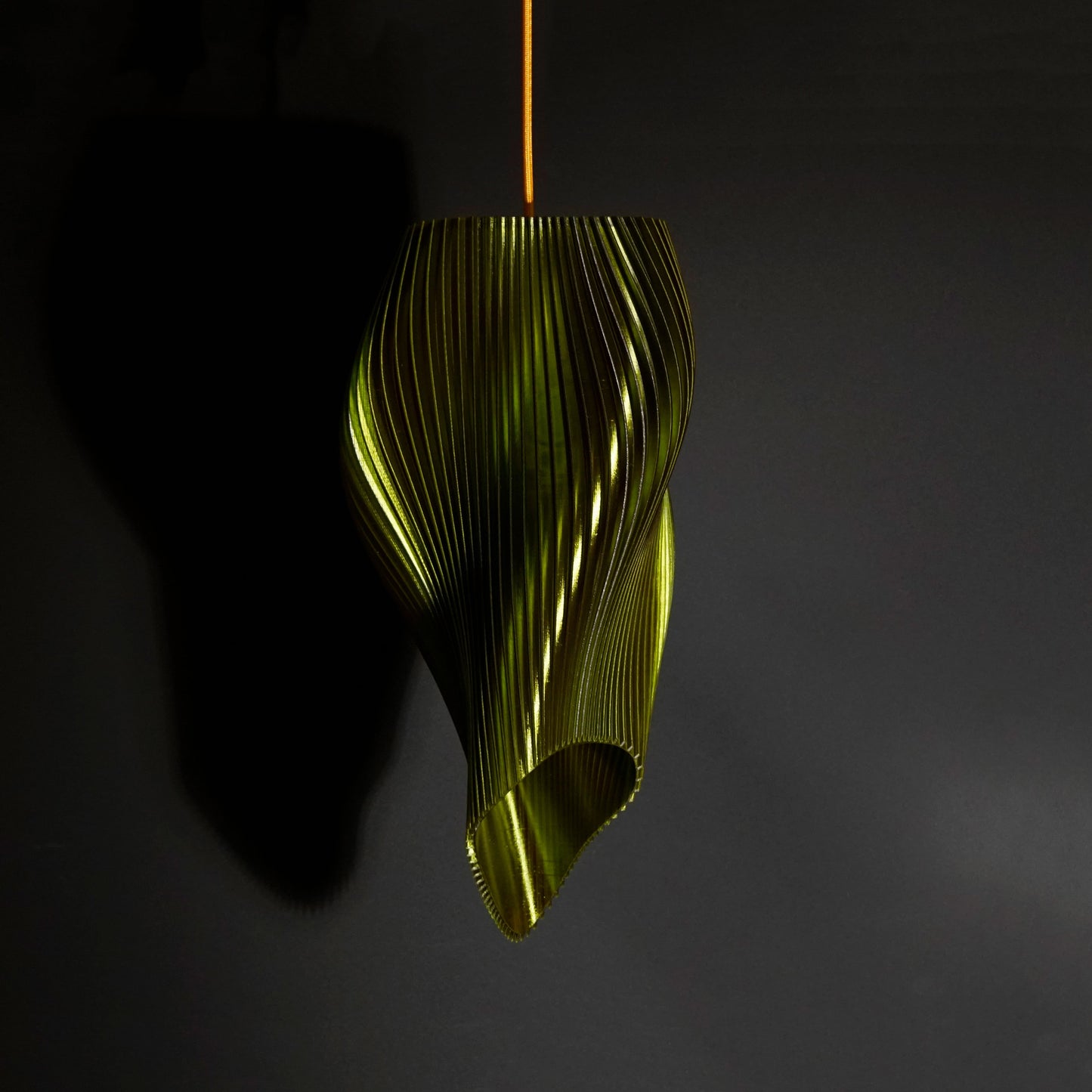 Green Long Wave Pendant Light illuminated, casting ambient glow and highlighting flowing sculptural curves