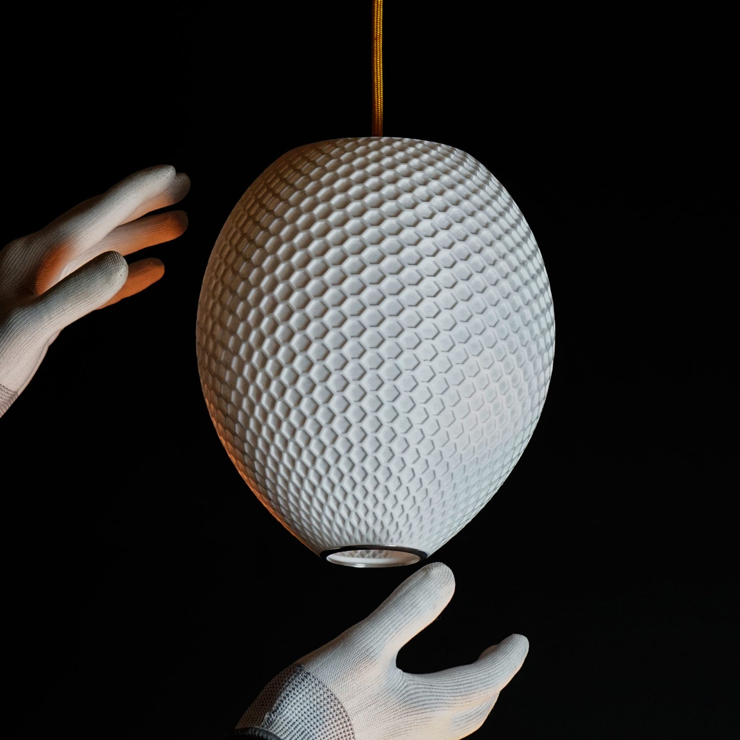 Close-up of hexagonal hive pattern on White Round Hive Pendant Light highlighting sculptural craftsmanship