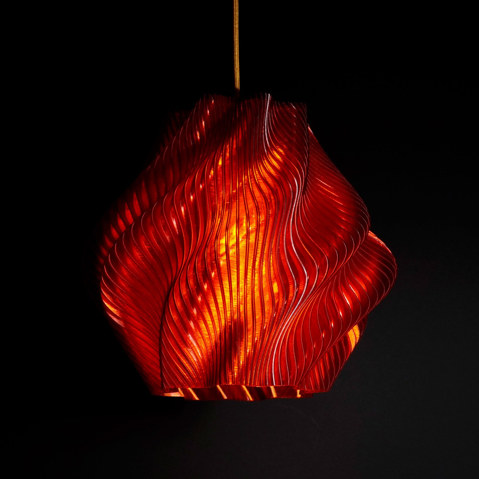 Crimson Red Spiral Wave Pendant Light illuminated, casting warm ambient glow and highlighting sculptural spiral ribs
