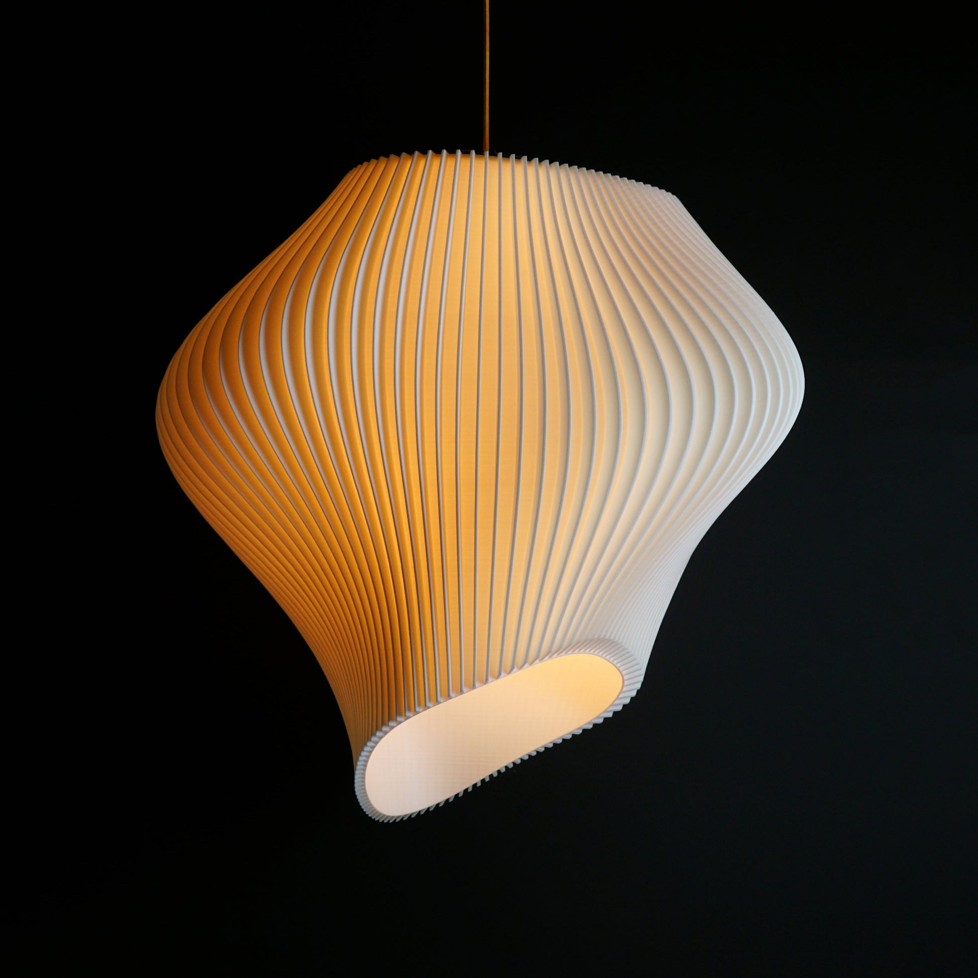 Extra Large White Wave Pendant Light illuminated casting ambient glow across sculptural wave design