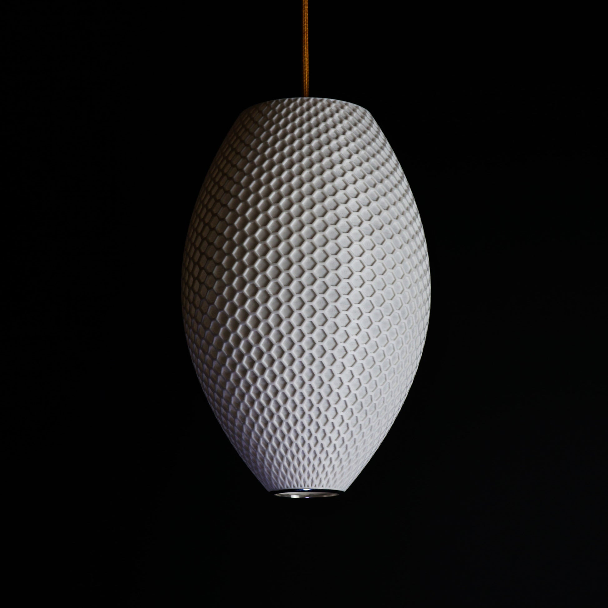 Long White Hive Pendant Light shown turned off highlighting elongated form and intricate geometric hive surface
