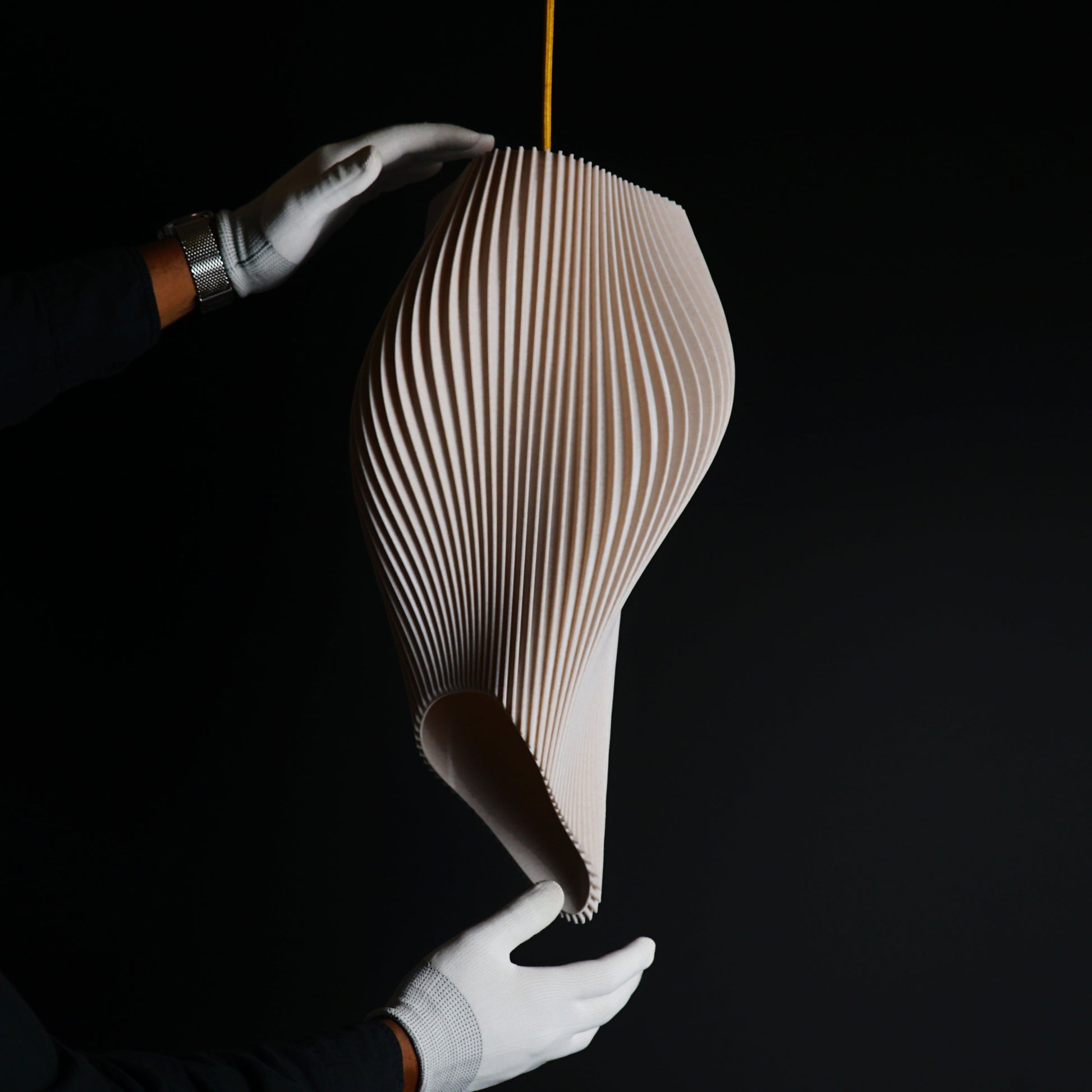 Close-up of Straw Long Wave Pendant Light highlighting sculptural curves and textured straw surface