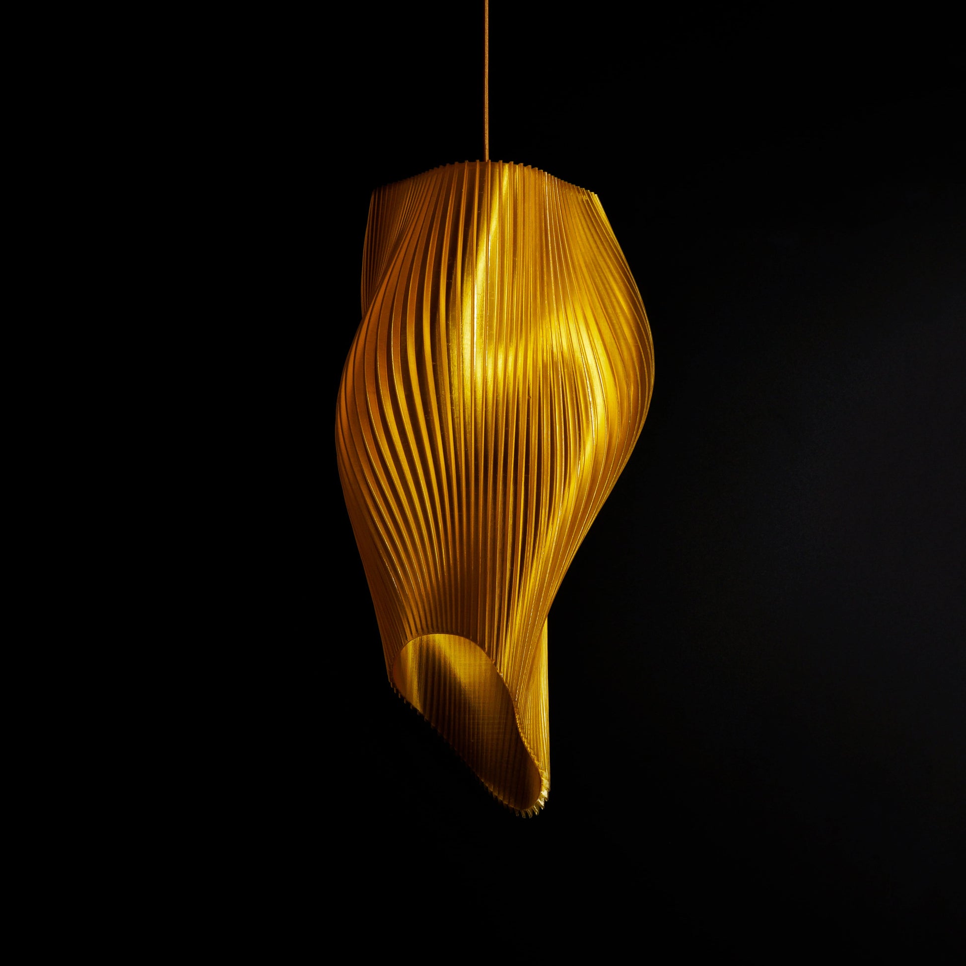 Close-up of Sun Gold Long Wave Pendant Light highlighting golden surface texture and dynamic sculptural form