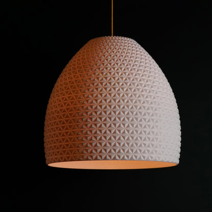White geometric dome pendant light illuminated, showcasing sculptural facets and modern luxury design