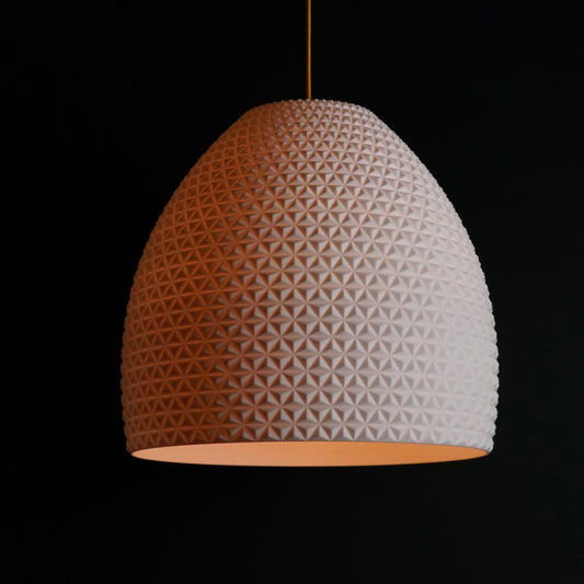 White geometric dome pendant light illuminated, showcasing sculptural facets and modern luxury design