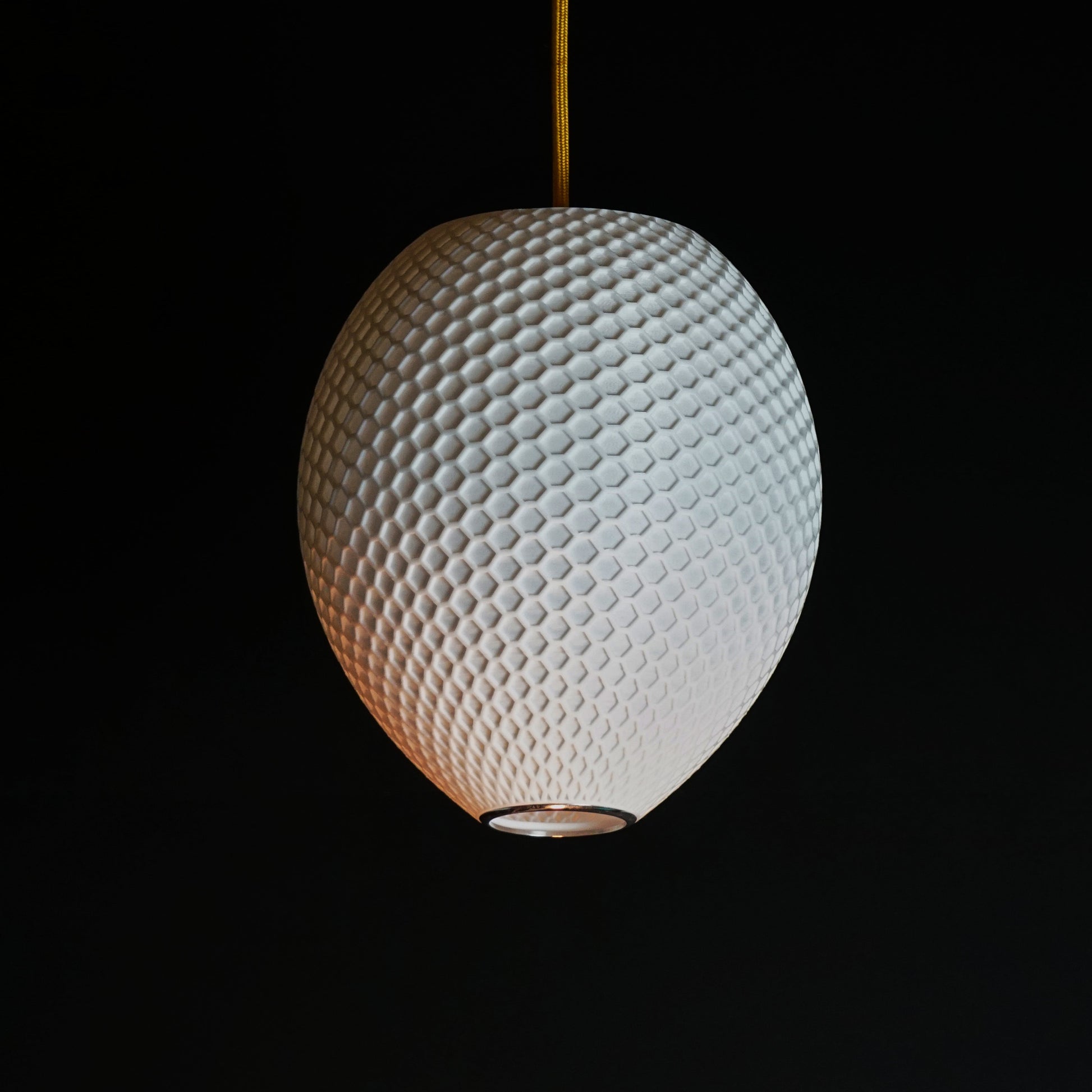 Side view of White Round Hive Pendant Light showing rounded sculptural form and geometric honeycomb pattern